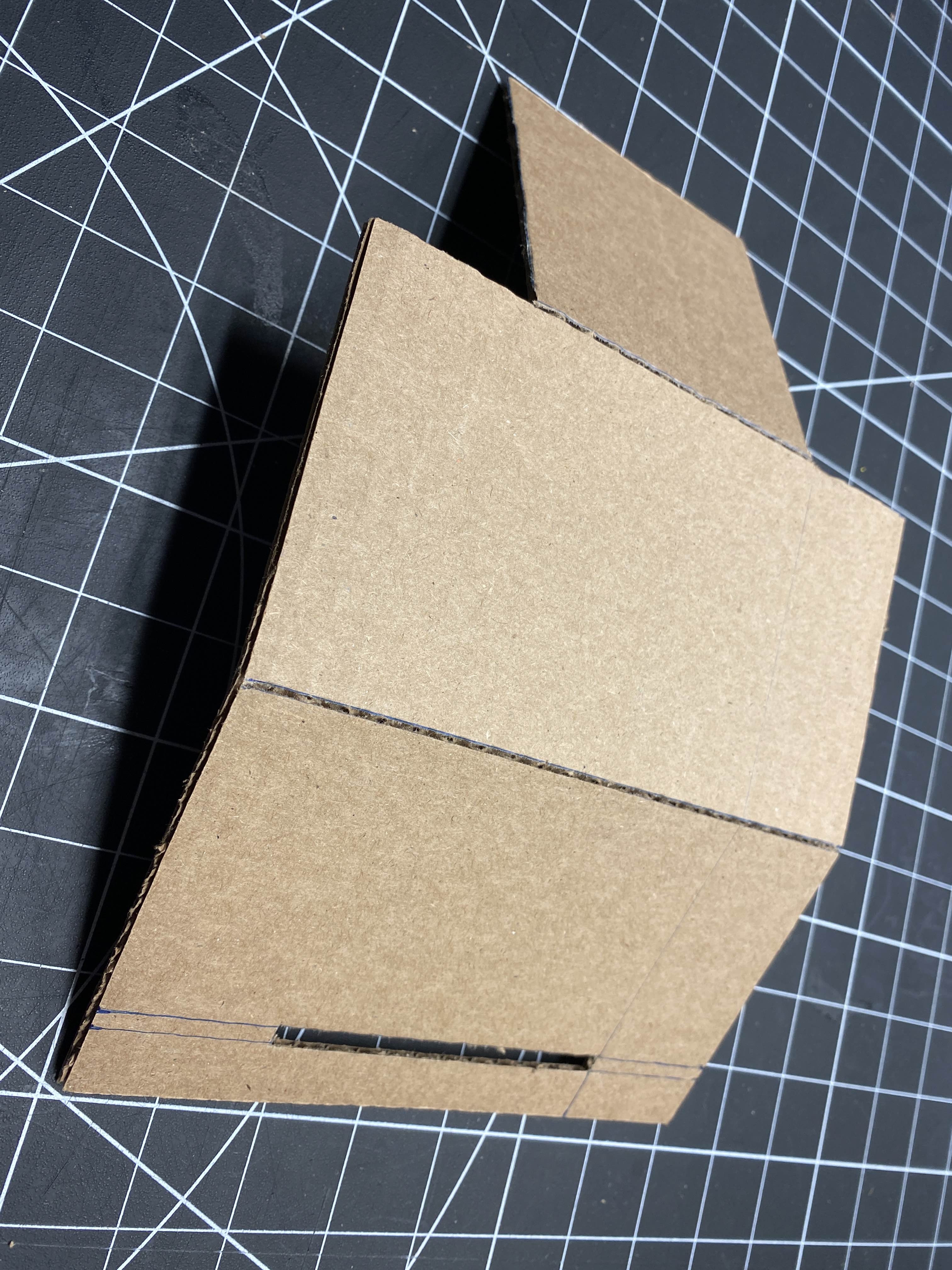 Making scores in the cardboard where it will be folded.